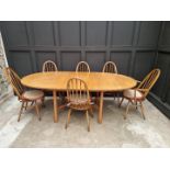 An Ercol drawleaf dining table and set of six chairs, to include a pair of elbow chairs, the table