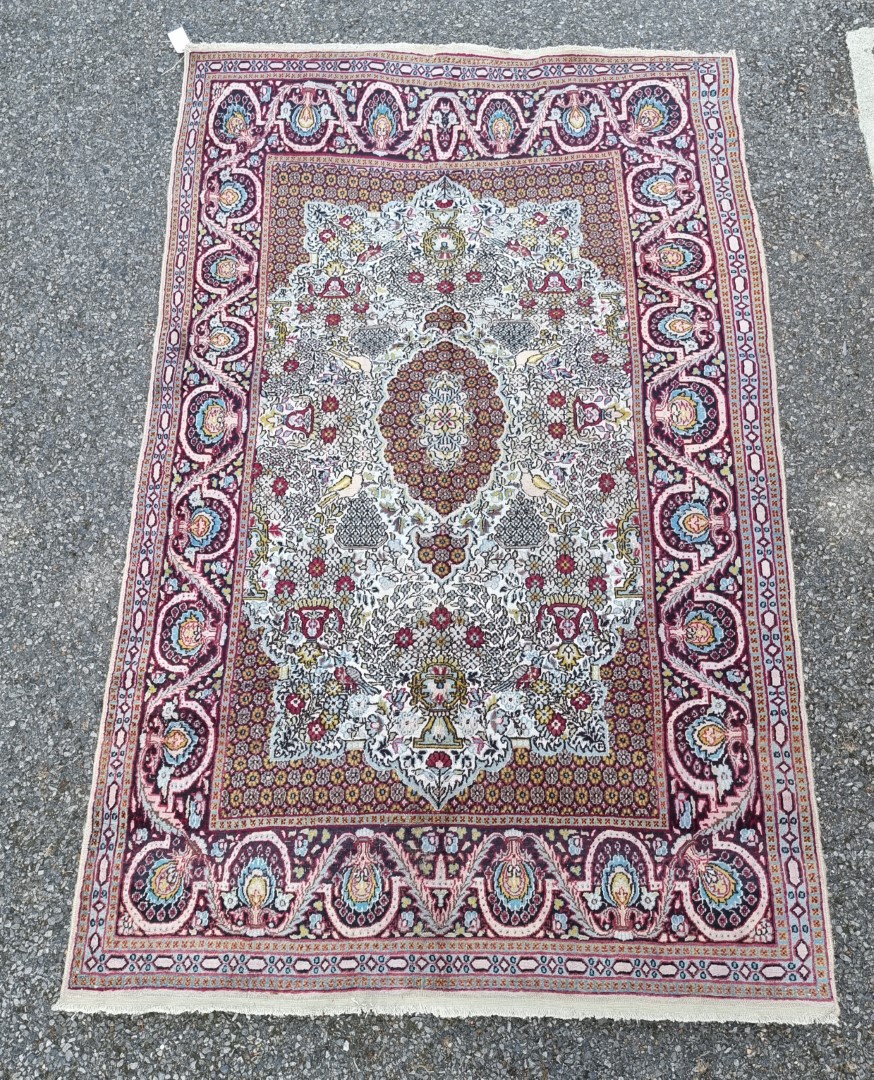 A part silk Tehran rug, having urn and bird decoration to central field, with floral borders, 186