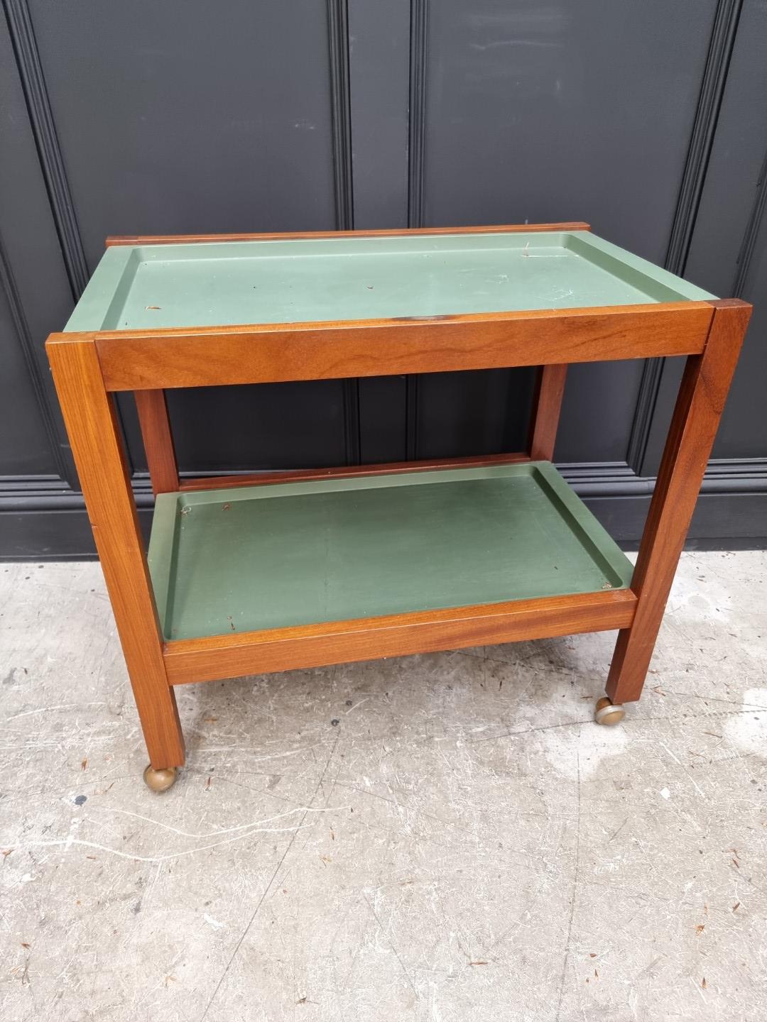 A mid-century teak two tier trolley, with removable green plastic trays, 76.5cm wide.