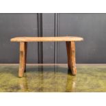 An antique pine milking stool, 20.5cm high x 38cm wide.