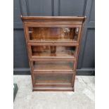 An early 20th century oak four tier sectional bookcase, in the Globe Wernicke style, 142cm high x