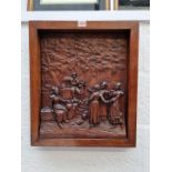 A Black Forest style carved oak relief panel of figures merrymaking, in oak frame, the whole 50.5