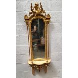An unusual antique giltwood framed pier mirror, incorporating a shelf and pair of candle branches,