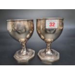 A pair of George III silver goblets, having engraved grape and leaf decoration, by Thomas Wallis (