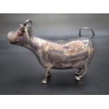 A Continental silver creamer in the form of a cow, having red gem set eyes, by Edwin Thompson