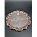 A silver piecrust salver, with engraved decoration, by Walker & Hall, Sheffield 1919, 28cm diameter,