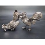 A pair of Dutch novelty pepperettes in the form of fighting cocks, stamped '835', by H. Hooykaas,
