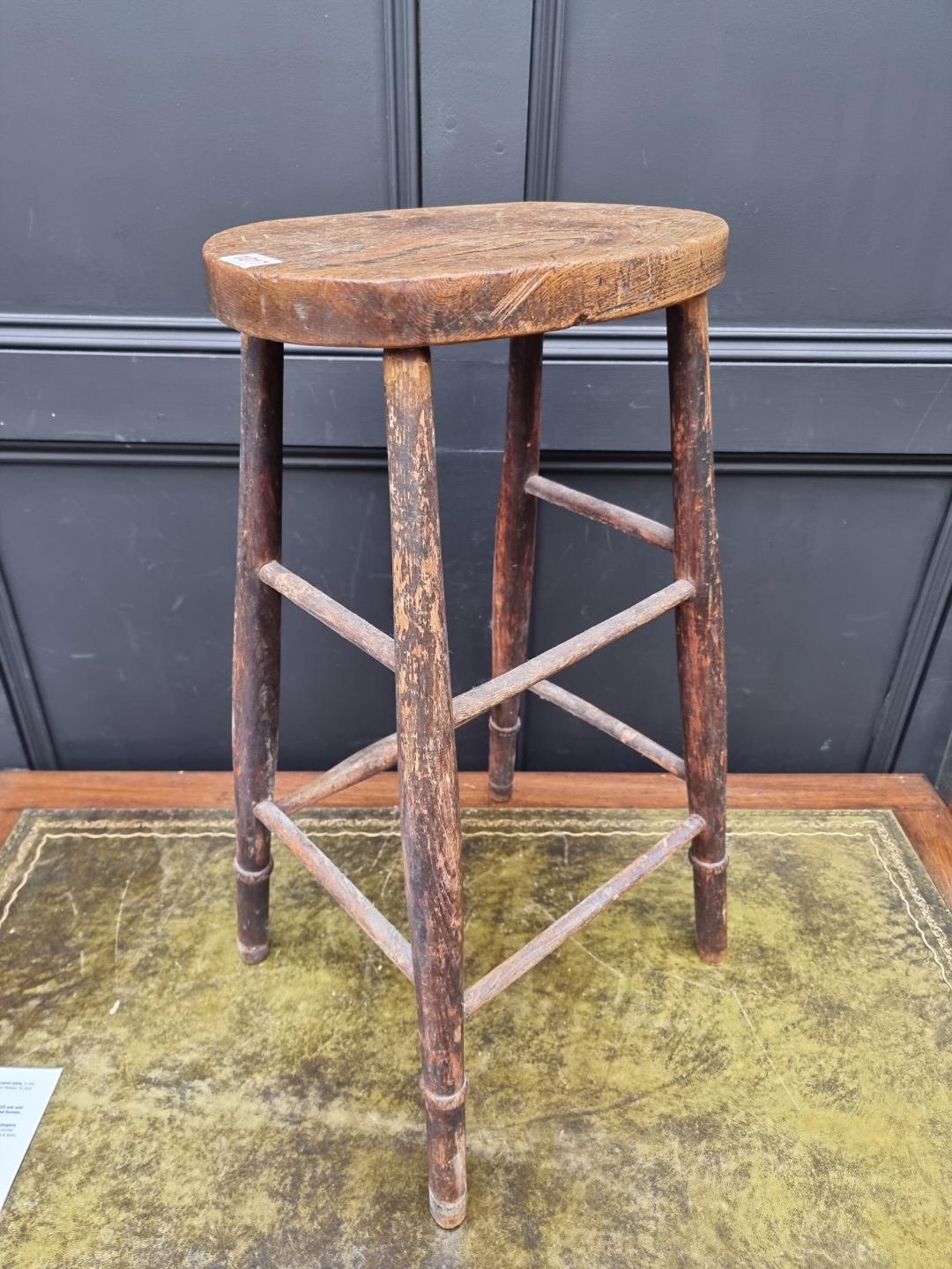 An old elm top high stool, 69cm high.