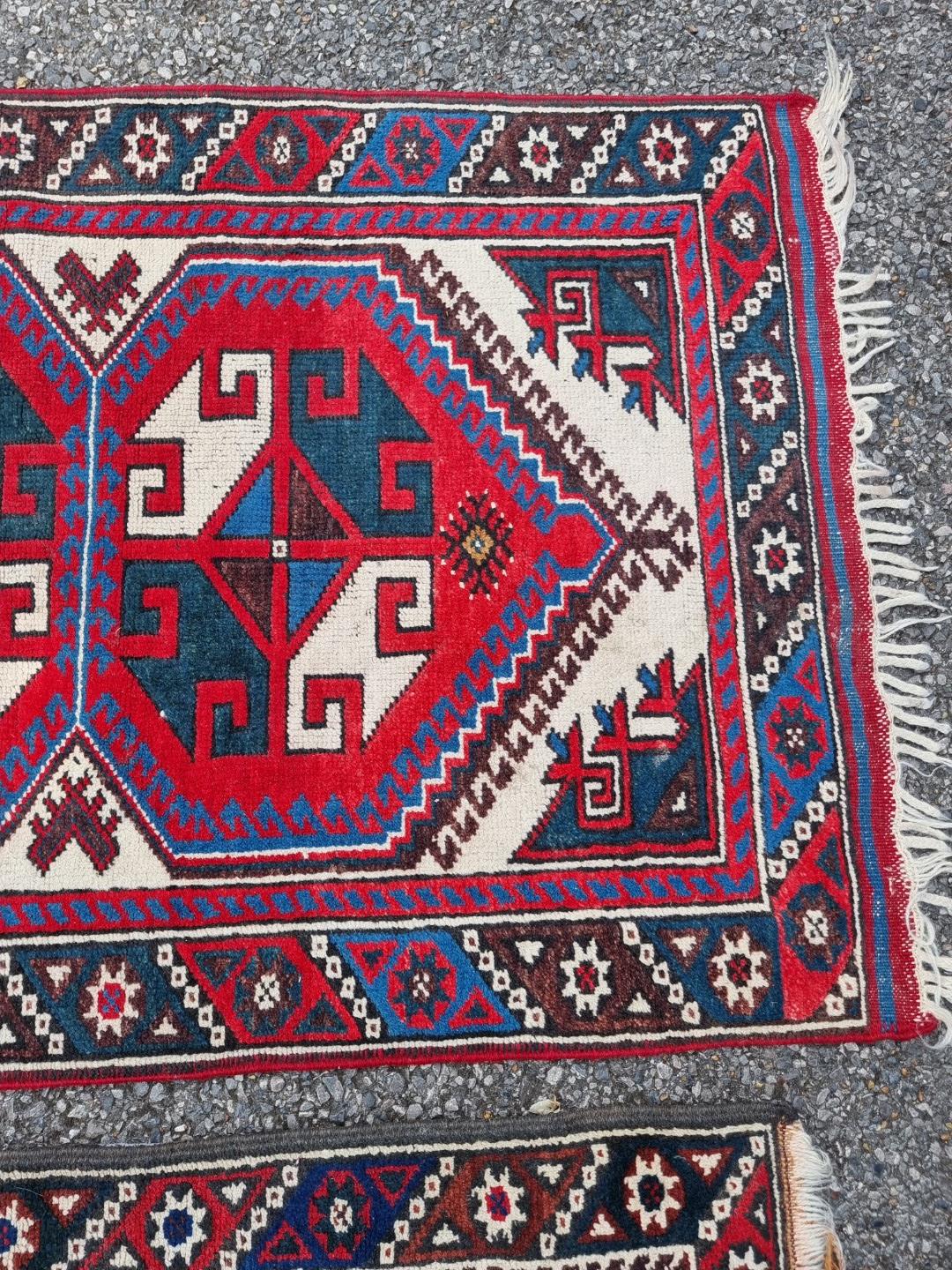 A small tribal rug, with floral borders, 119 x 76cm wide; together with another similar rug, 110 x - Image 5 of 5