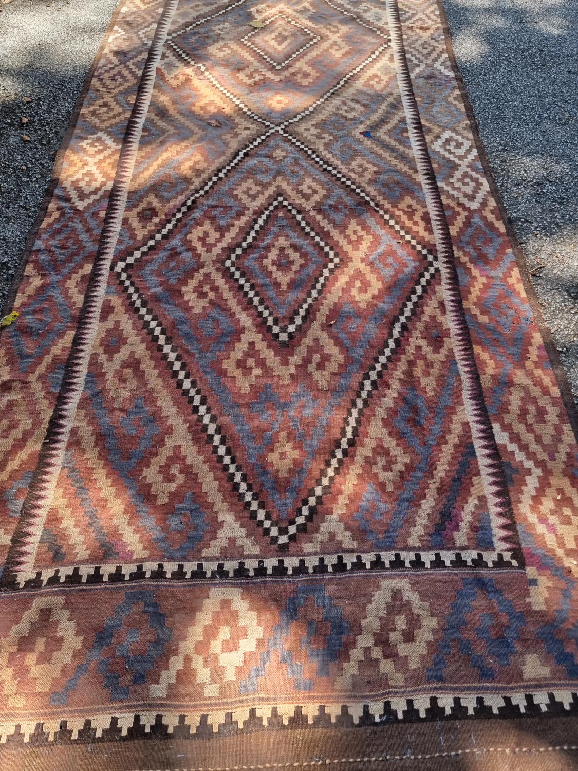 A large Afghan Kelim carpet, having two geometric medallions, 407cm x 165cm, (a.f.). - Image 2 of 3