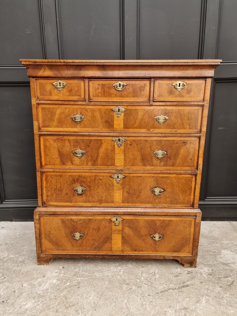 A George II walnut and crossbanded chest on stand, 105.5cm wide, (lacking legs).