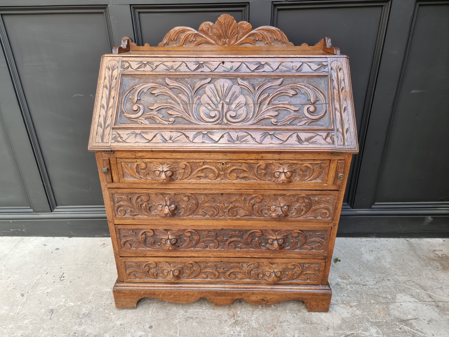 A late 19th/early 20th century carved oak bureau, 91cm wide.