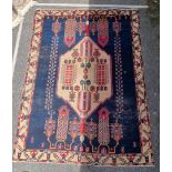 A Persian rug, with central geometric medallion and geometric borders, 236 x 177cm.