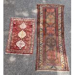 A Tribal rug, having four central medallions, with geometric design, 260 x 102cm; together with a