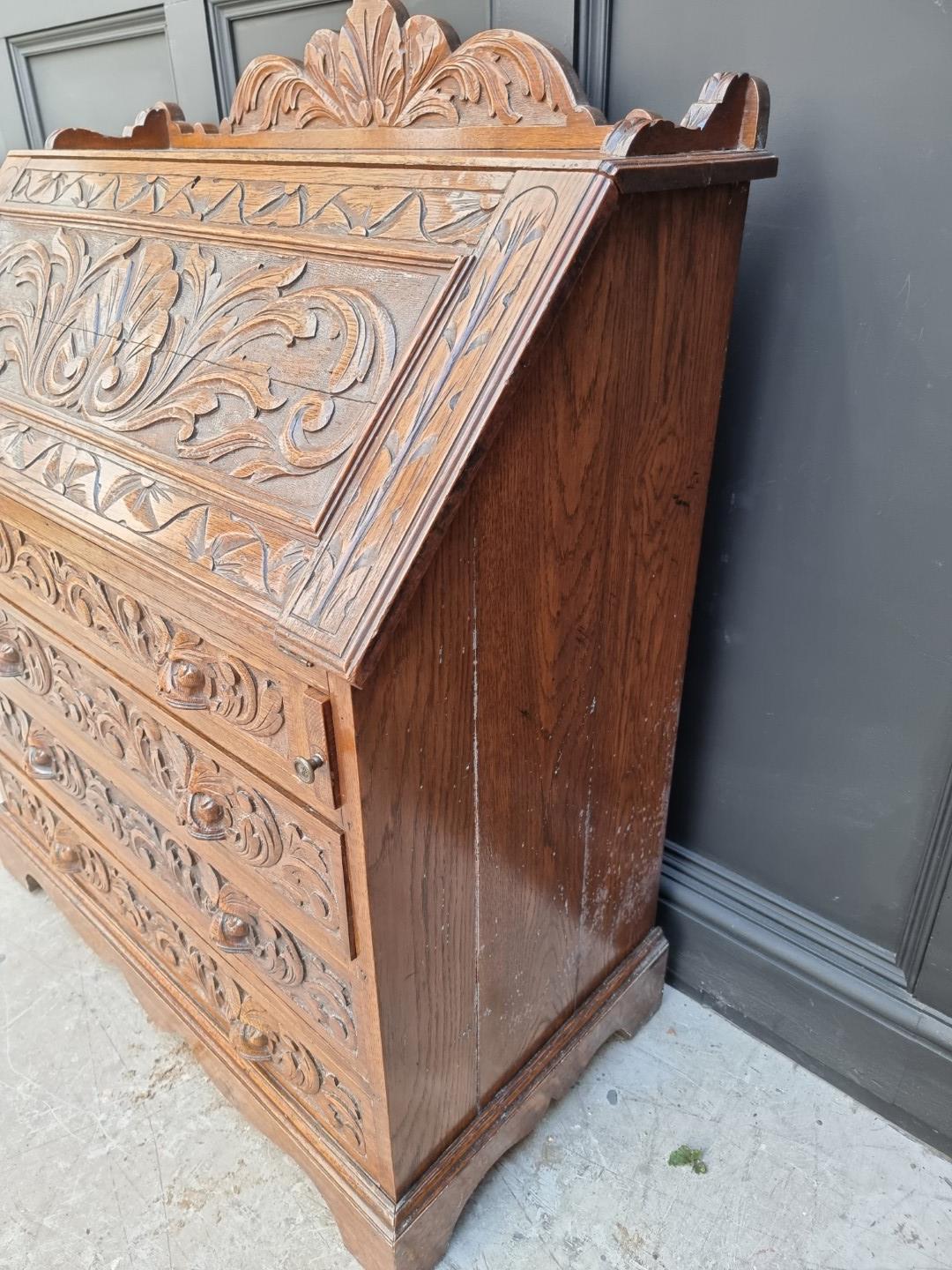 A late 19th/early 20th century carved oak bureau, 91cm wide. - Image 2 of 6