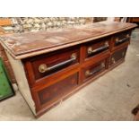 A large antique mahogany shop counter, with six drawers, 234cm wide, (a.f.).