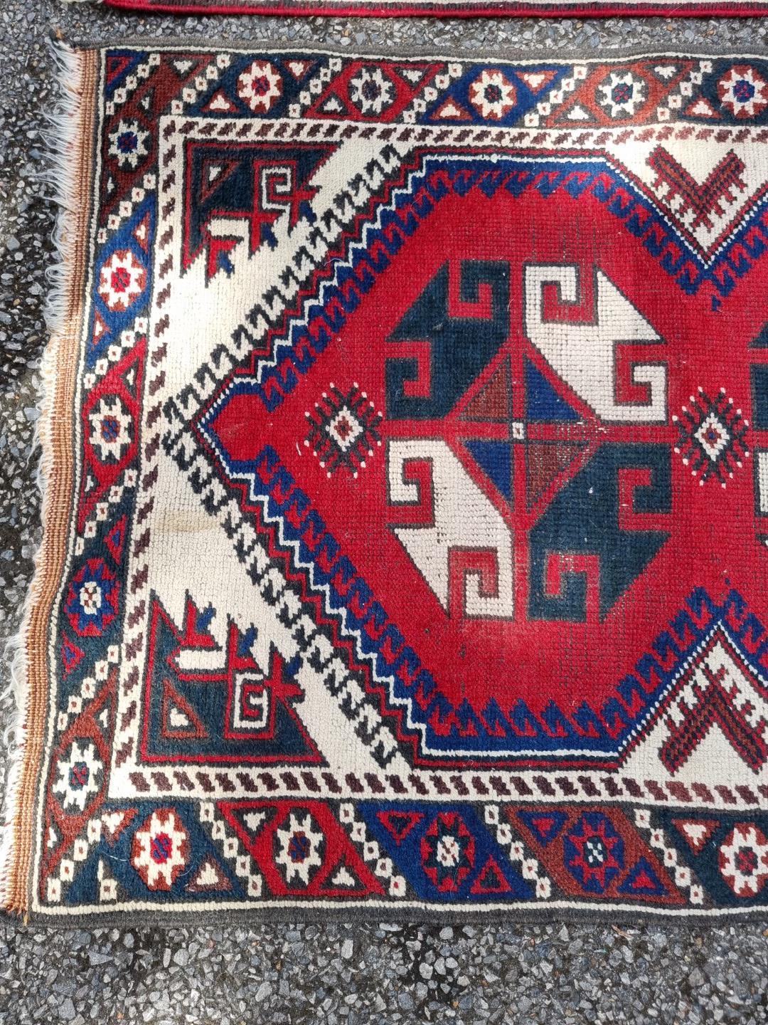 A small tribal rug, with floral borders, 119 x 76cm wide; together with another similar rug, 110 x - Image 3 of 5