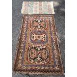 A Persian rug, having three central medallions, with geometric borders, 221 x 139cm; together with a