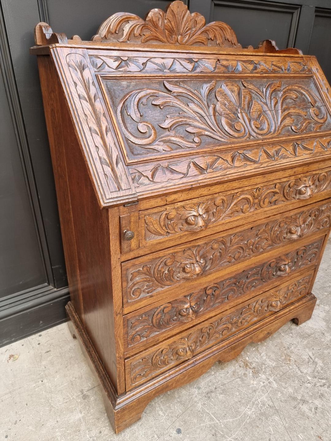 A late 19th/early 20th century carved oak bureau, 91cm wide. - Image 4 of 6