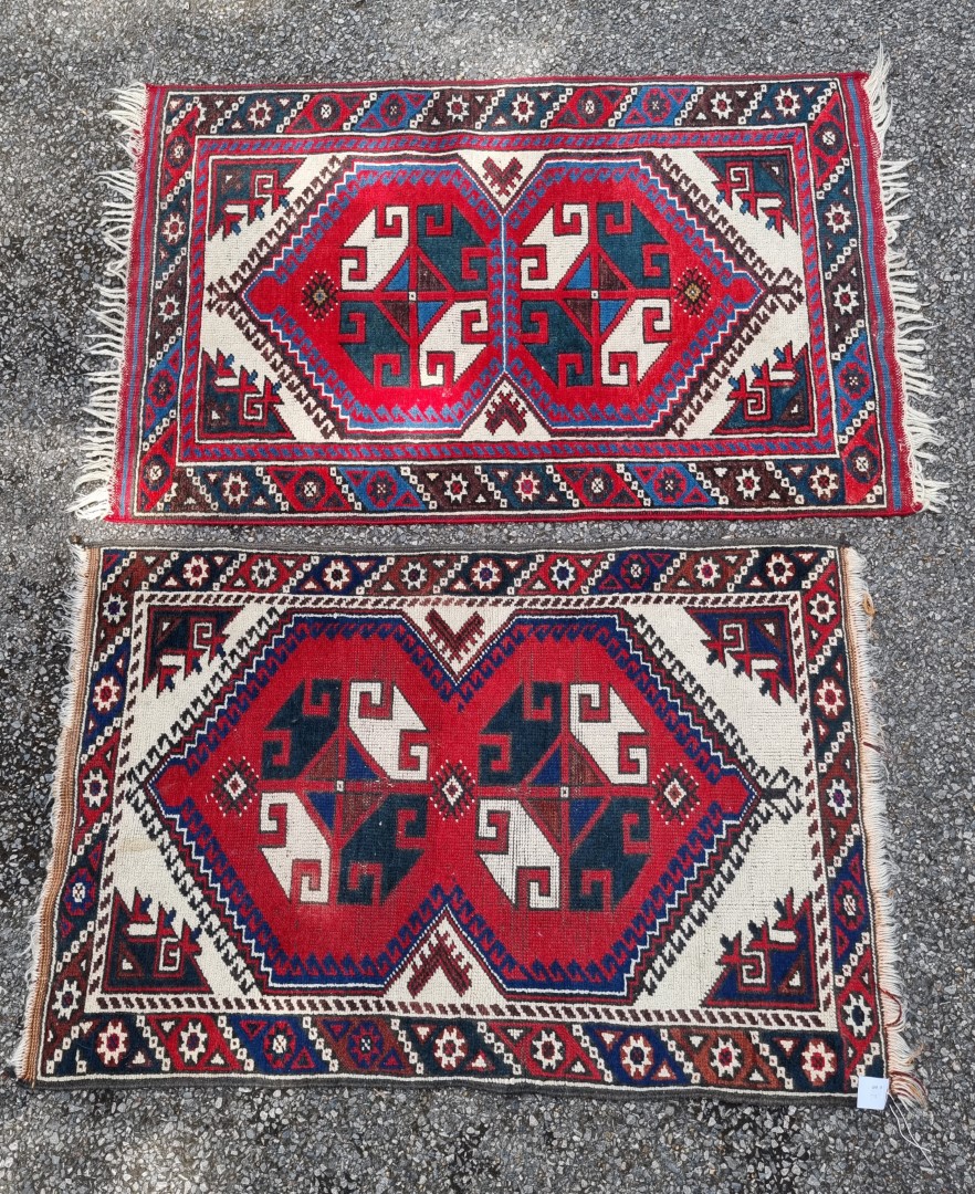 A small tribal rug, with floral borders, 119 x 76cm wide; together with another similar rug, 110 x