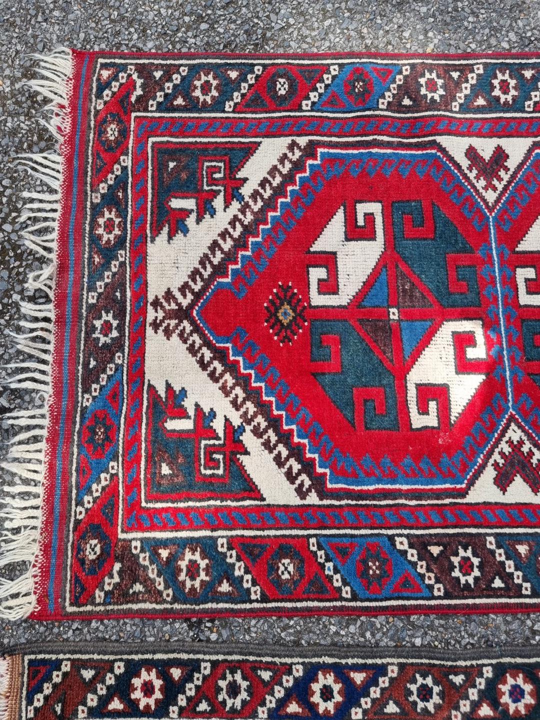 A small tribal rug, with floral borders, 119 x 76cm wide; together with another similar rug, 110 x - Image 4 of 5