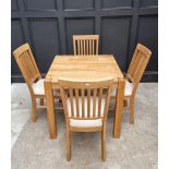 A contemporary pale oak dining table and four chairs, the table 80cm wide.