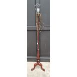 An old mahogany tripod standard lamp.