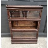 A Globe Wernicke oak three tier sectional bookcase, 86cm wide, (middle tier lacking glass).