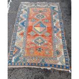 A Tribal rug, having geometric decoration to central field, with floral borders, 251 x 171cm.