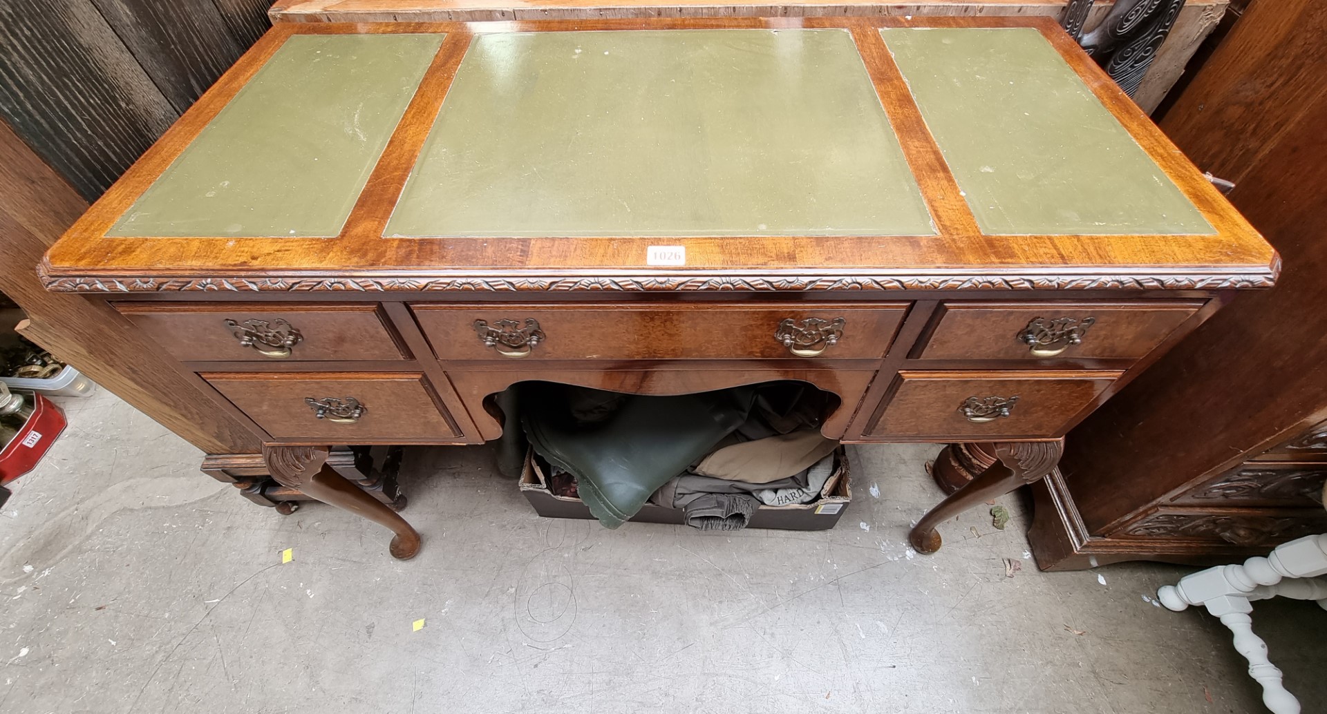 A 1930s walnut kneehole desk, 107cm wide.