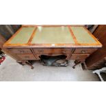 A 1930s walnut kneehole desk, 107cm wide.