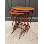 A nest of three 1930s walnut oval occasional tables, largest 56cm wide.