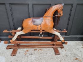 A large painted wood rocking horse, 165cm long.