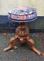 A carved elm adjustable tripod piano stool.