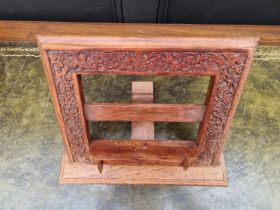 An Eastern carved hardwood folding easel back prayer book stand, 36cm wide.