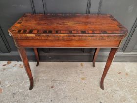 An early 19th century rosewood and coromandel card table, with double gateleg, 91.5cm wide.