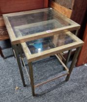 A nest of two brass and glass occasional tables, largest 46cm wide.