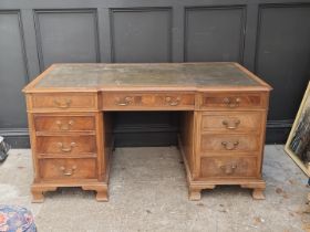 A reproduction walnut partner's pedestal desk, of inverted breakfront form, 152cm wide.