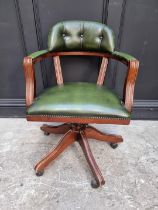 A reproduction mahogany and green leather desk chair.