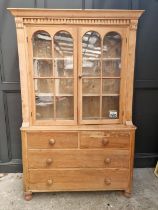 An antique pine bookcase, 131.5cm wide.