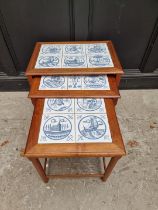 A nest of three mid-century teak and tile inset occasional tables, largest 56cm wide.