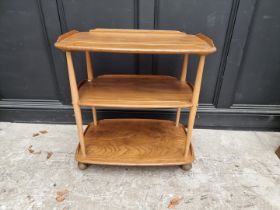 A vintage Ercol elm three tier trolley, 70cm wide.