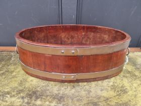 A 19th century mahogany and brass bound shallow wine cooler or jardiniere, 57.5cm wide.