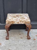 A 1930s, 18th century style, carved walnut and upholstered stool.