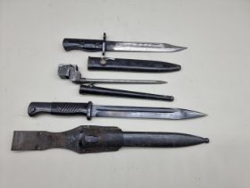 A British SLR L1A3 bayonet and scabbard; together with two other bayonets and scabbards. (3)