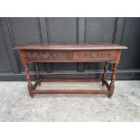An antique oak two drawer side table, 125cm wide.