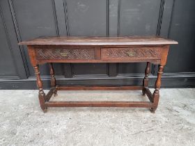 An antique oak two drawer side table, 125cm wide.