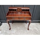 Au unusual reproduction carved mahogany desk, 103.5cm wide.