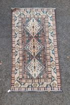 A tribal rug, having three central medallions, with allover geometric decoration, with geometric