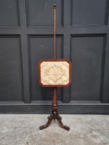 A Victorian mahogany tripod polescreen.